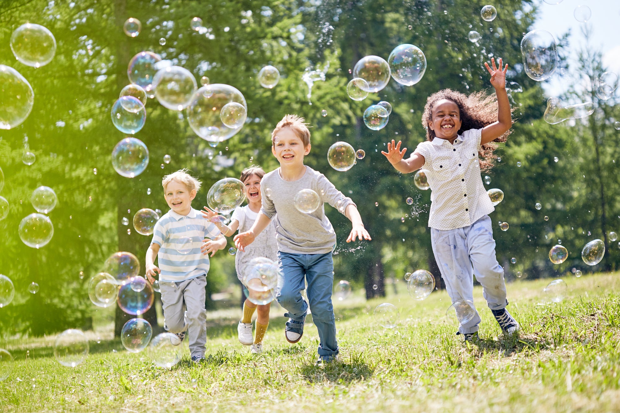 Kids playing outdoors with bubbles